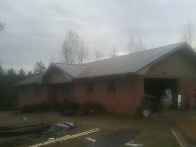 Gray metal roof on a stucco house with an attached garage in Winter Park